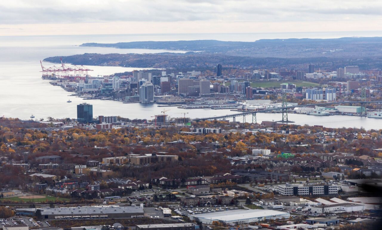 Aerial of Halifax in fall. Macdonald Bridge visible in the centre with the south end container port in the background.
