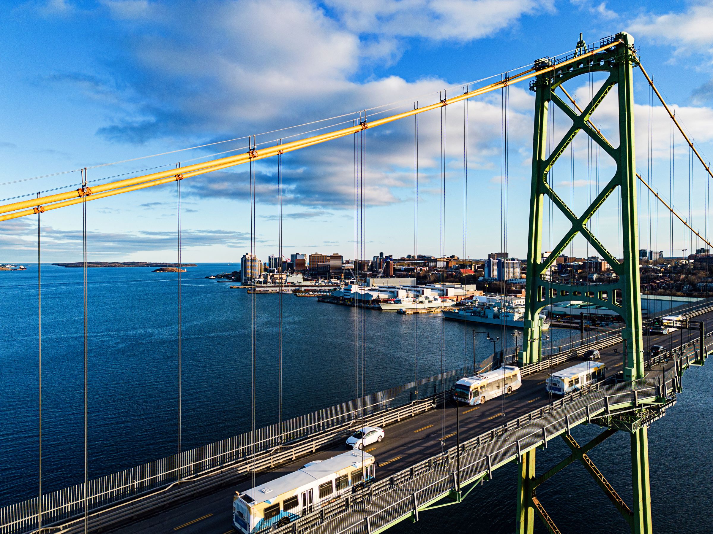 Aerial view of several Halifax Transit buses travelling on the Macdonald Bridge.