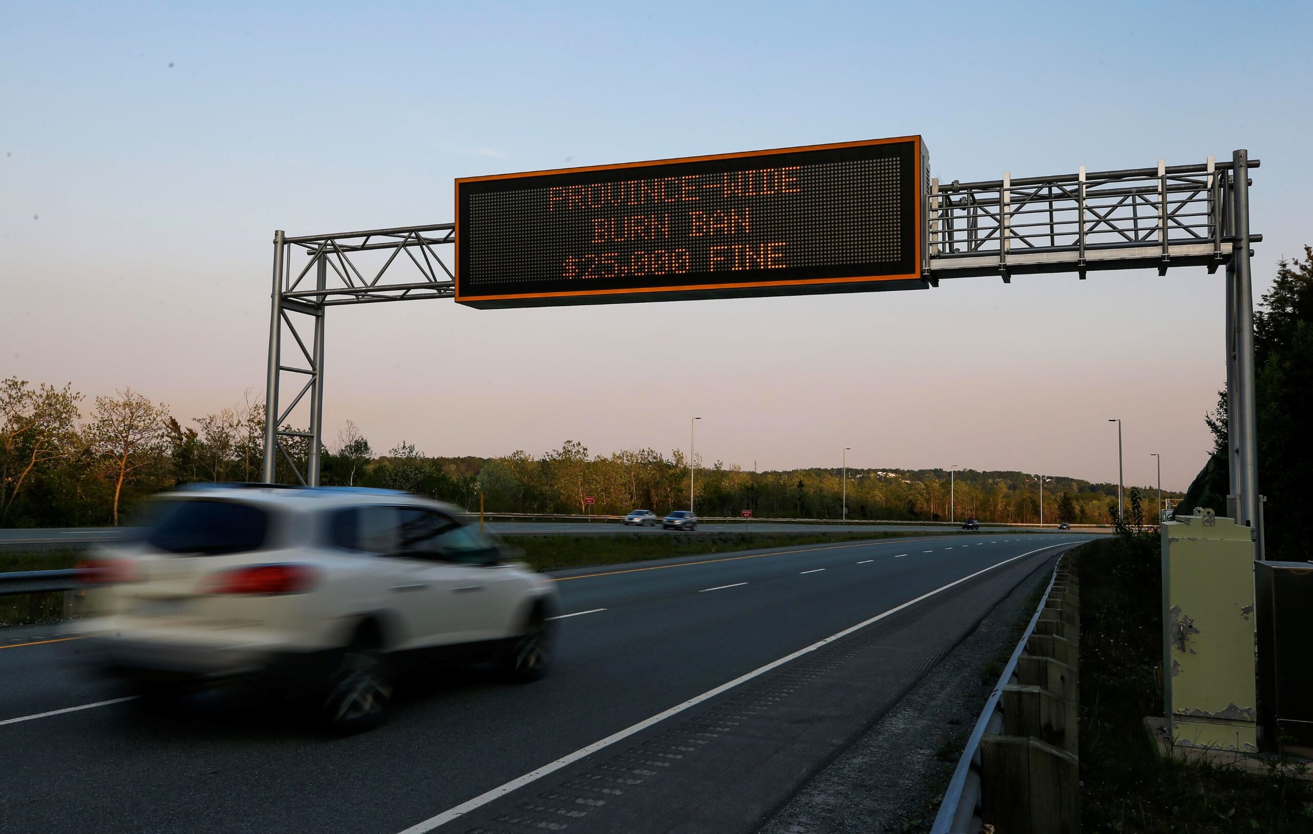 A digital message sign displays a wildfire ban message along Highway 118.