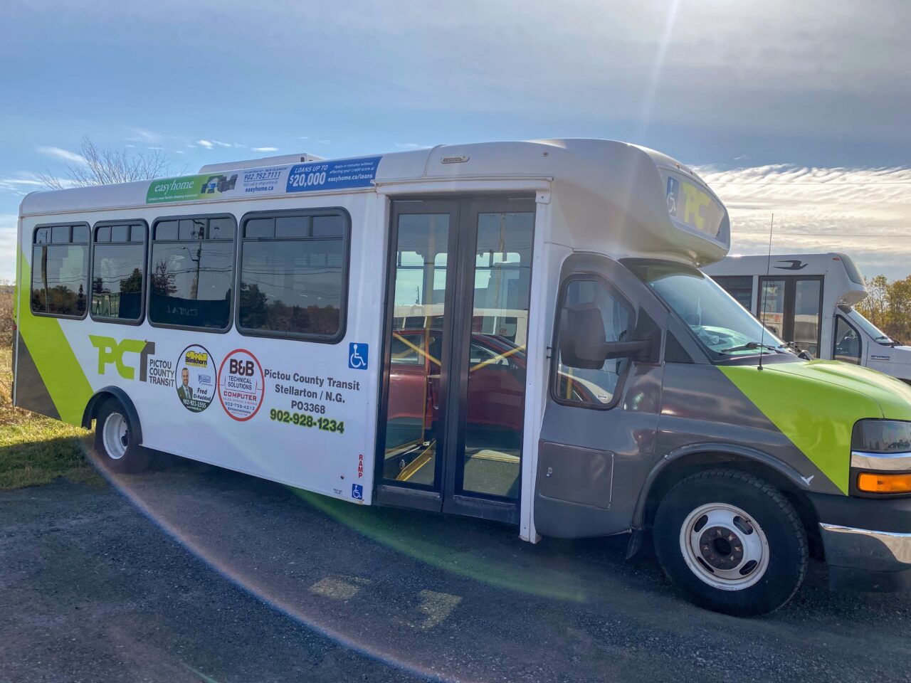 A side profile of a small bus with Pictou County Transit livery and logo.