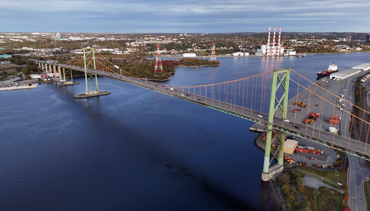 Aerial view of the A Murray MacKay Bridge facing toward Dartmouth. Tufts Cove is visible in the background.
